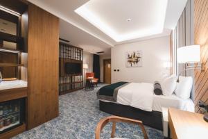 a hotel room with a bed and a desk at Bristol Hotel Podgorica in Podgorica