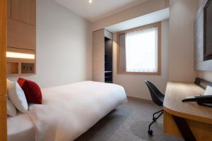 a hotel room with a bed and a desk at Hotel JAL City Haneda Tokyo in Tokyo