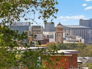 a view of a city with a clock tower at Tranquil apartment in the city in Newcastle