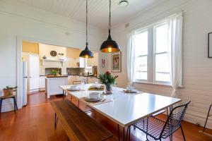 a kitchen and dining room with a table and chairs at Nowra Beauty in Nowra