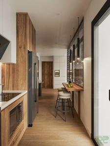 a kitchen with a refrigerator and a table with stools at Chung cư Tecco Center Point Thanh Hóa in Thanh Hóa