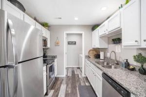 a kitchen with white cabinets and a stainless steel refrigerator at Spruce Valley in Branson