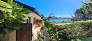 a house with a view of the ocean at Opononi Lighthouse Motel in Opononi