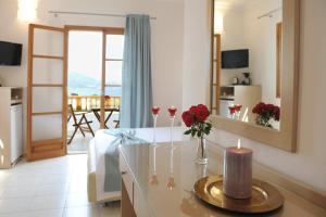 a living room with a table with flowers and candles at Konstantinos in Adamantas