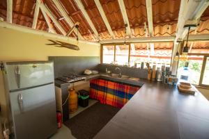 a kitchen with a refrigerator and a sink at Paraiso Perdido in Mompiche