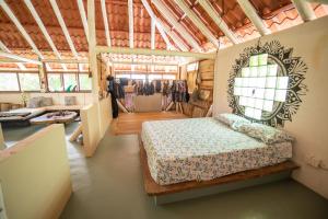 a bedroom with a bed and a mirror in a room at Paraiso Perdido in Mompiche