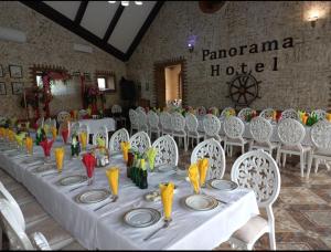 a long table with white tables and white chairs at Panorama Resort Oghuz in Oğuz +84 photos