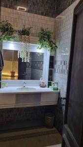 a bathroom with a sink and a mirror at Modernistic Antique Stay in Jeddah