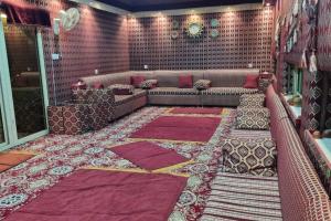 a living room with a couch and a rug at Modernistic Antique Stay in Jeddah