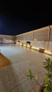 an empty patio at night with lights on a building at Modernistic Antique Stay in Jeddah