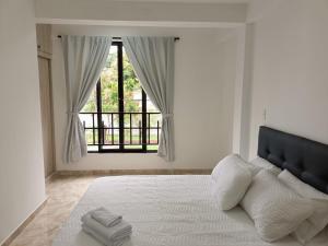 Un pat sau paturi într-o cameră la El mejor apartamento en Cali 2B