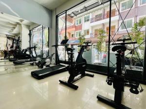 a gym with treadmills and exercise bikes in a room at PJ Patong Resortel in Patong Beach
