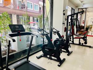 a gym with two exercise bikes and a window at PJ Patong Resortel in Patong Beach