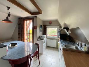 eine Küche mit einem Tisch und einem Waschbecken in der Unterkunft Quiet duplex apartment in St Briac sur Mer in Saint-Briac-sur-Mer