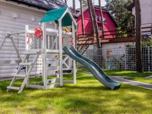 a playground with a slide and a swing at Comfortable, two-story holiday houses, Pobierowo in Pobierowo