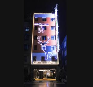 a hotel with a sign on the side of it at Herb Art Hotel in Keelung