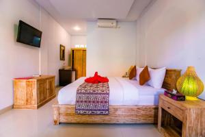 Postel nebo postele na pokoji v ubytování Dede Cottage Ubud