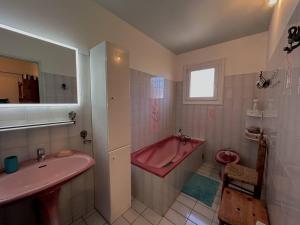 a bathroom with a pink tub and a sink at Sublime Villa Climatisée Familiale avec Extérieurs Spacieux – Quartier Calme - FR-1-388-215 in Argelès-sur-Mer