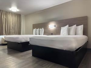 Ένα ή περισσότερα κρεβάτια σε δωμάτιο στο Americas Best Value Inn Austin