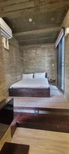 a bedroom with a bed and a large window at Enishi Resort Villa in Huxi