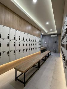 a locker room with benches and lockers at Emerald Garden International Hotel in Medan