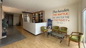 a lobby with a bar with a sign on the wall at Emerald Garden International Hotel in Medan