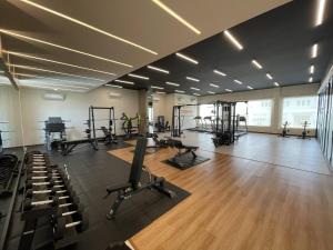 a gym with several treadmills and exercise bikes in it at Emerald Garden International Hotel in Medan