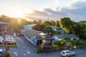 a street with cars parked in a parking lot at Modern 3 bed overlooking Hagley Park in Christchurch