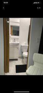 a bathroom with a toilet and a sink at Perfect suite #3 in San Juan