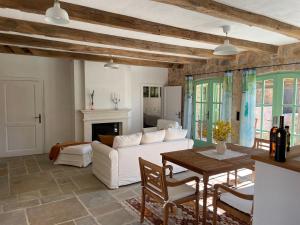 a living room with a white couch and a table at Hotel Village Balatura - exclusive VEGGIE in Tribalj