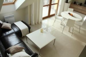 a living room with a couch and a table at Apartament Morski in Rewal