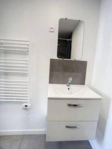 biała łazienka z umywalką i lustrem w obiekcie SUPER Studio Tout équipé WIFI 2PERS w mieście Saint-Quentin