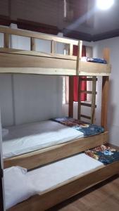 two bunk beds in a dorm room with two mattresses at Kri's house in Fortuna