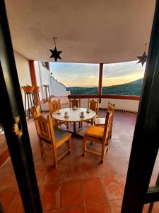 a dining room with a table and chairs and a view at La Casa Grande in Guanajuato