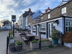 a fence in front of a restaurant with a table at Historic Picturesque Apartment Pembroke in Pembrokeshire