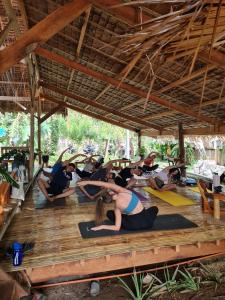 a group of people doing yoga in a pavilion at Wonderland in Siquijor
