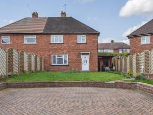 a brick house with a brick driveway in front of it at Briar Cottage in Knaresborough