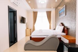 a bedroom with a bed and a brick wall at Hoa Hướng Dương Hotel in Phan Rang