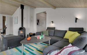 a living room with a couch and a table at Stunning Home In Bogense With Sauna in Bogense