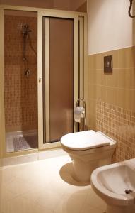 a bathroom with a shower and a toilet and a sink at Casina delle Palme in Trapani