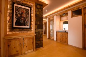 a bathroom with a painting on a stone wall at Stone Hedge Hotel in Nubra