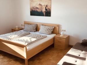 a bed with two pillows on it in a bedroom at Ferienwohnung Wia Dahoam in Steingädele