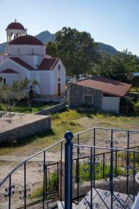 a gate in front of a building with a mosque at Perdika Sea Soul in Perdhika