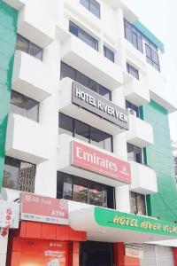 a building with several signs on the side of it at Hotel River View in Sylhet