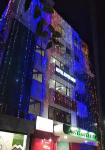 a building with christmas lights on the side of it at Hotel River View in Sylhet