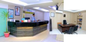 a man standing at a counter in an office at Hotel River View in Sylhet