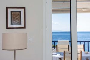 a dining room with a view of the ocean at Perdika Sea Soul in Perdika