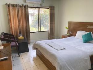 - une chambre avec un grand lit et une fenêtre dans l'établissement Hotel River View, à Sylhet