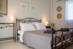 a bedroom with a large bed with white pillows at Perdika Sea Soul in Perdika