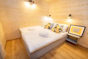 a small bedroom with a bed in a wooden room at Pearl of Sava Wild Waters in Ljubljana